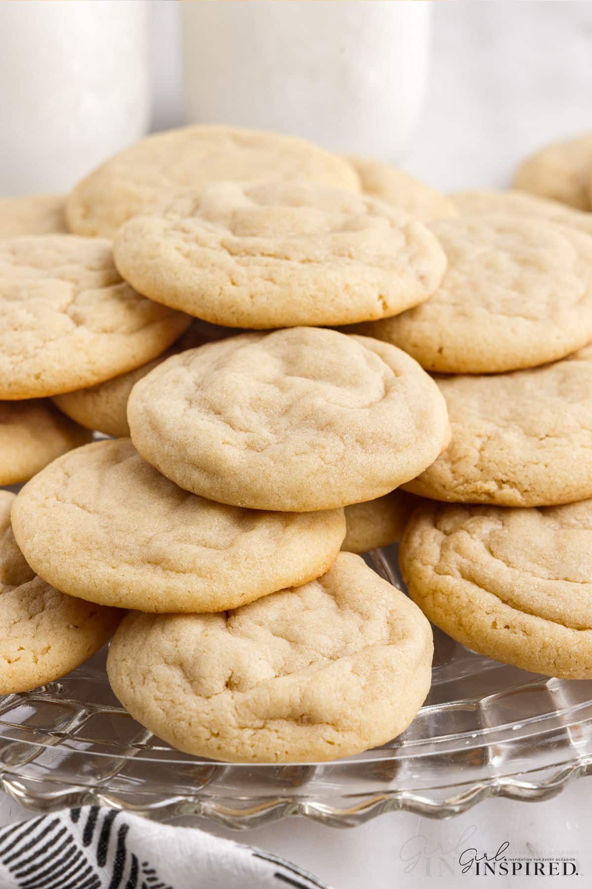 Platter of soft and chewy sugar cookies stacked in layers.