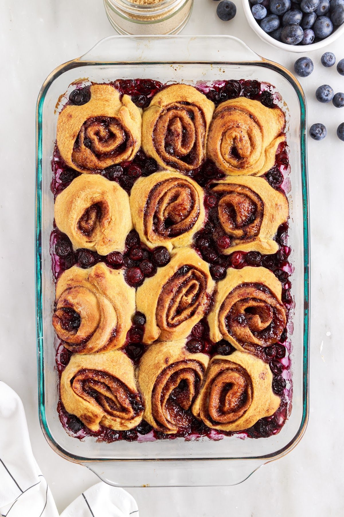 Fully bakes rolls to a golden brown on the counter with other ingredients in the background.