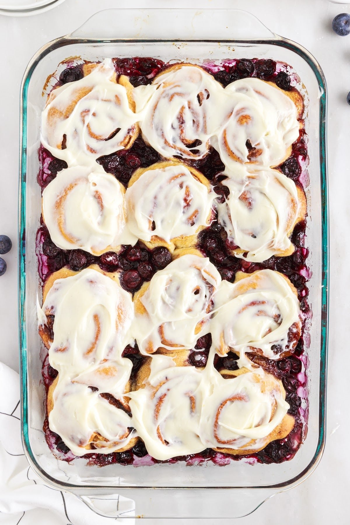 Frosted rolls in a baking dish, ready to eat.