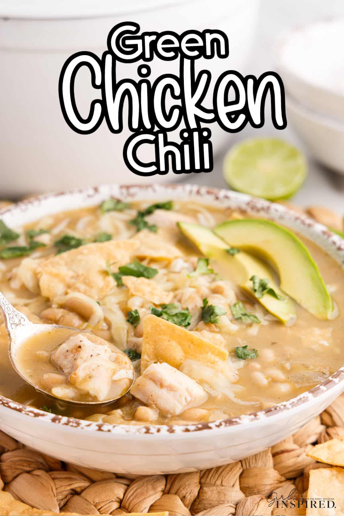 Large bowl of Green Chicken Chili with garnish on top of cilantro, avocado, tortilla strips, with text overlay.