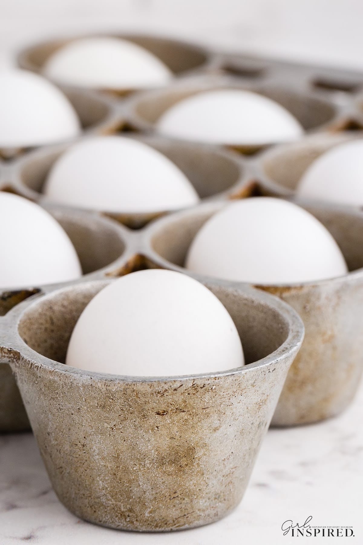Close up of a muffin tray filled with Hard-Boiled Eggs in the Oven!