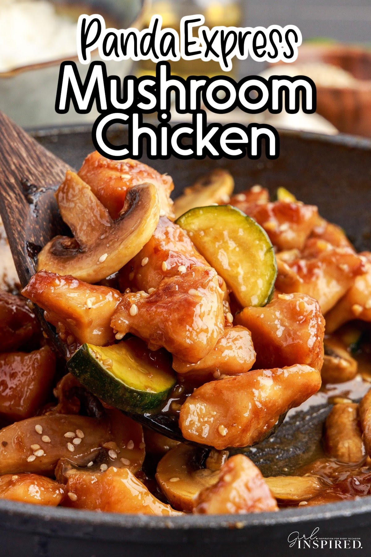 Large skillet of Panda Express Mushroom Chicken, with some scooped on a wooden spoon to show the ingredients, with text overlay.