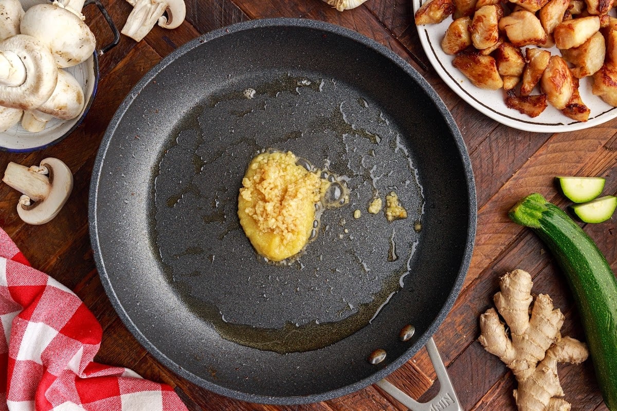 Garlic and ginger in a pan to warm up before the veggies are put into it.  Other ingredients are in the background.