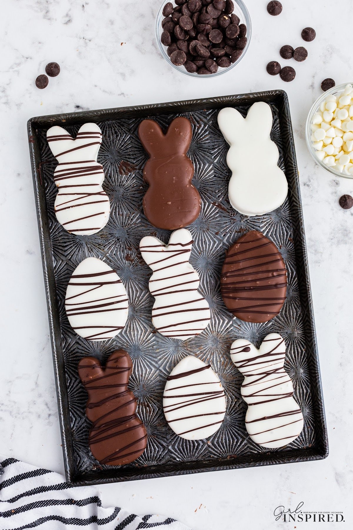 Baking sheet filled filled with peanut butter chocolate eggs and bunnies, decorated.