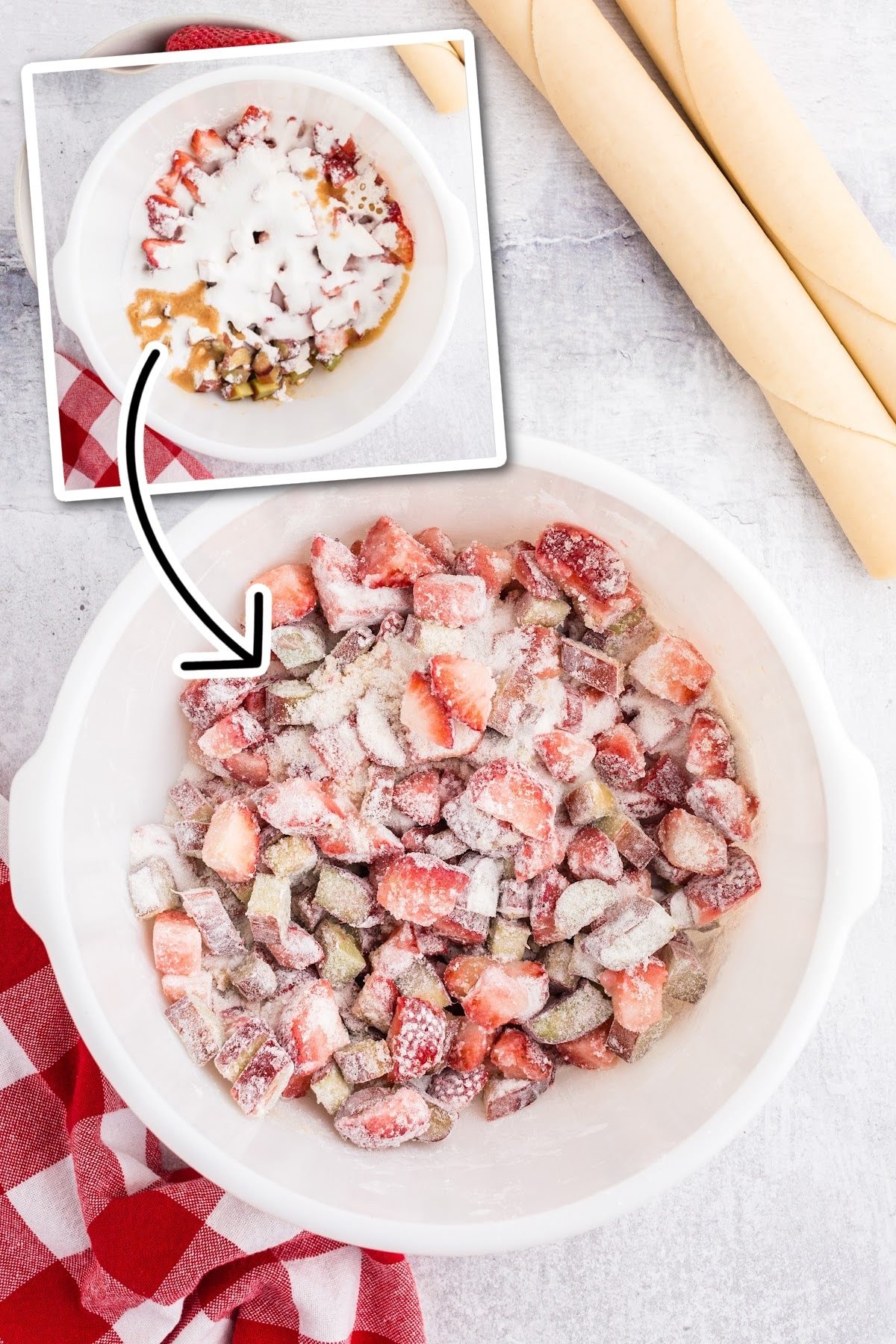 Mixing the dry ingredients together with the strawberries and rhubarb, and pie dough in the background.