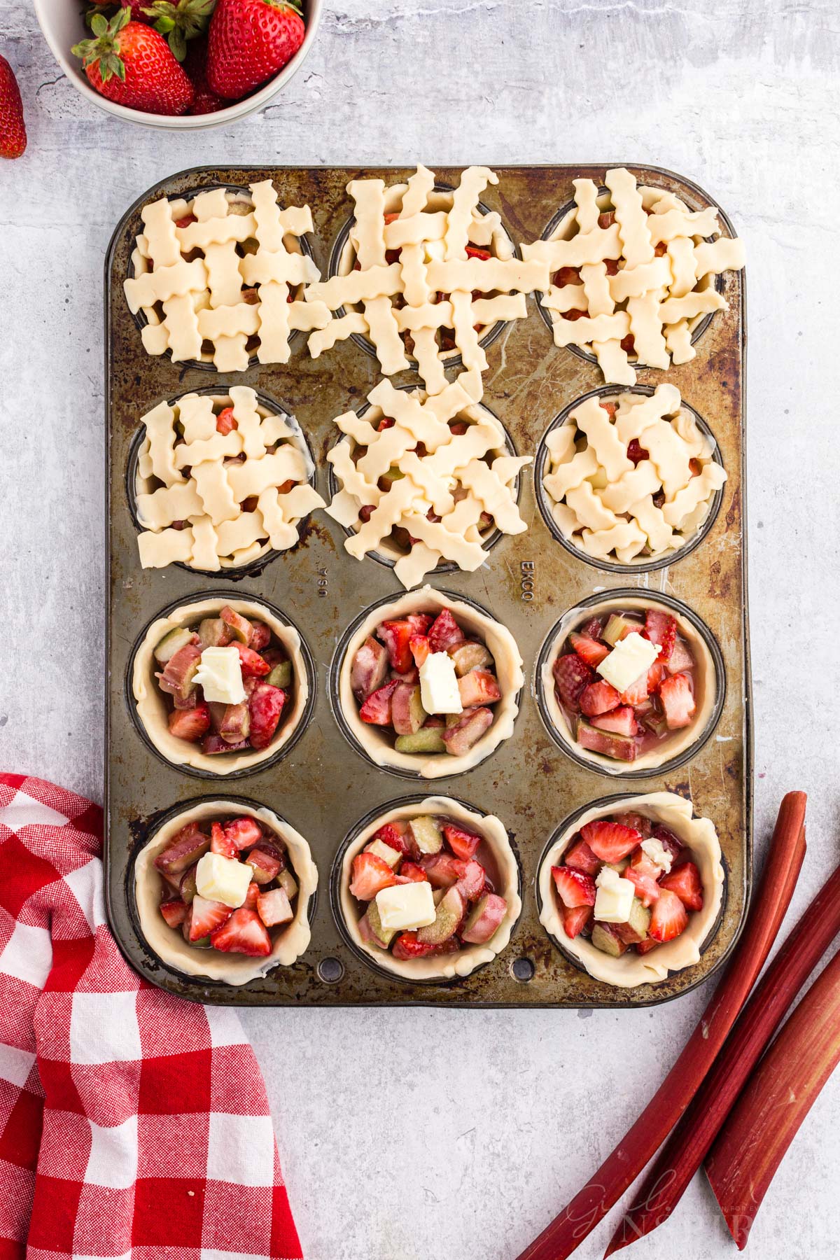 Showing the process to decorate the top of the mini pies with the lattice pie dough.