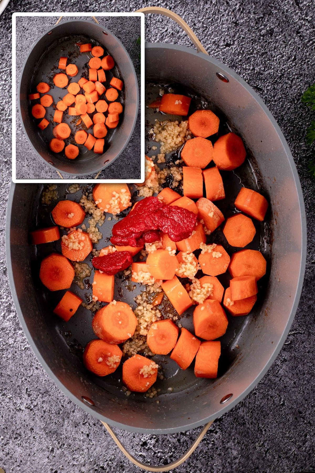 Carrots, tomato paste, and spices in a stockpot.