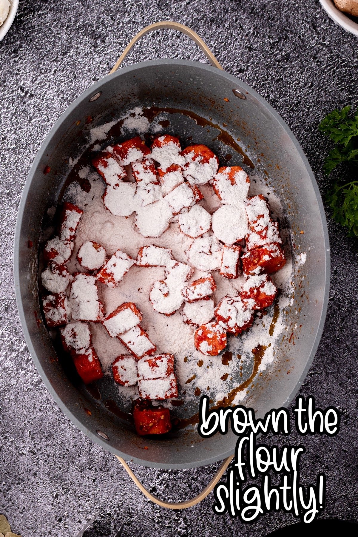 Flour mixture sprinkled over vegetables in stock pot.