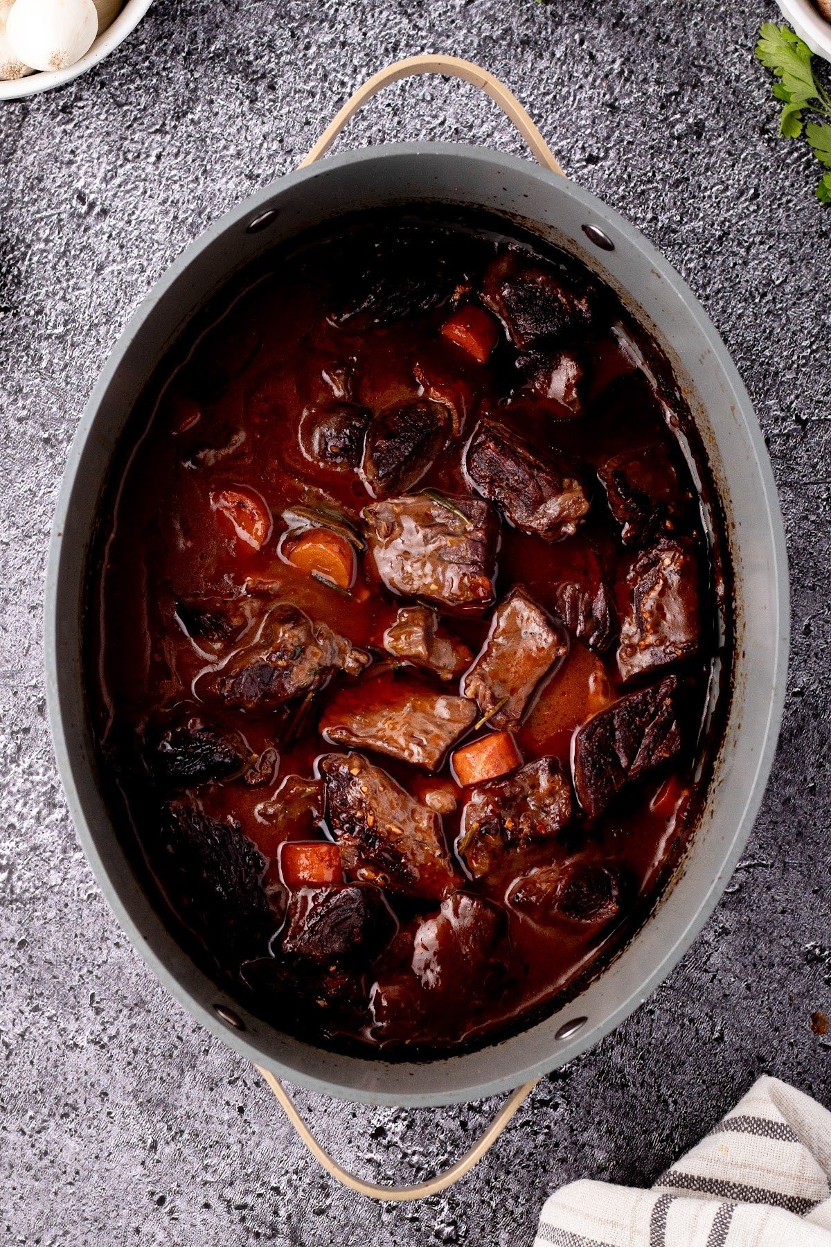 Cooked beef bourguignon in stock pot.