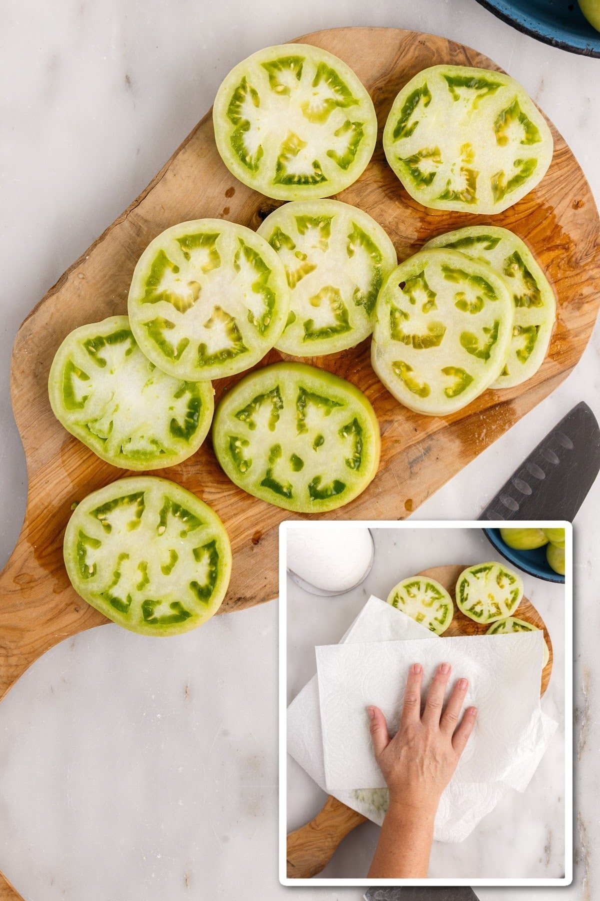Sliced green tomatoes on a wooden cutting board, patting dry.