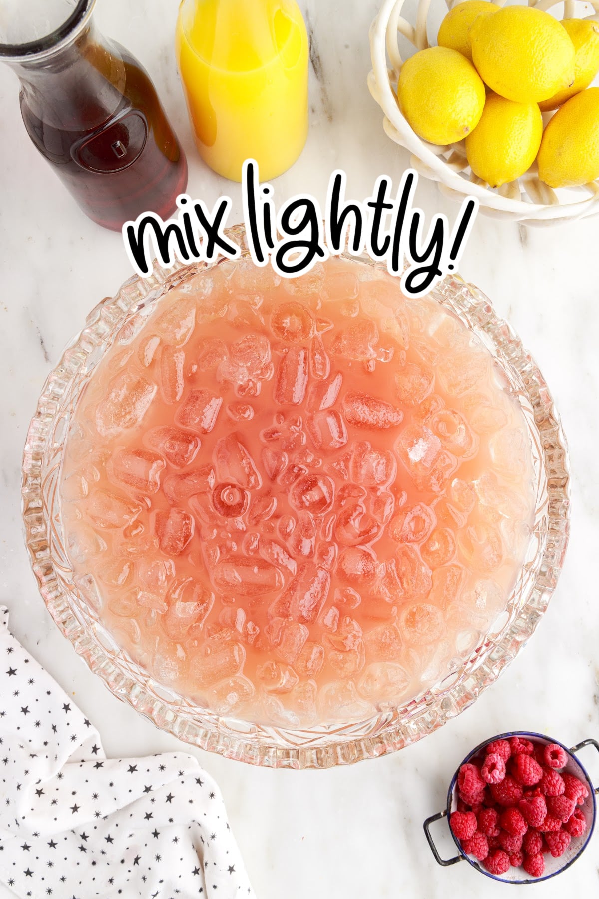 Mix lightly all ingredients together in the punch bowl