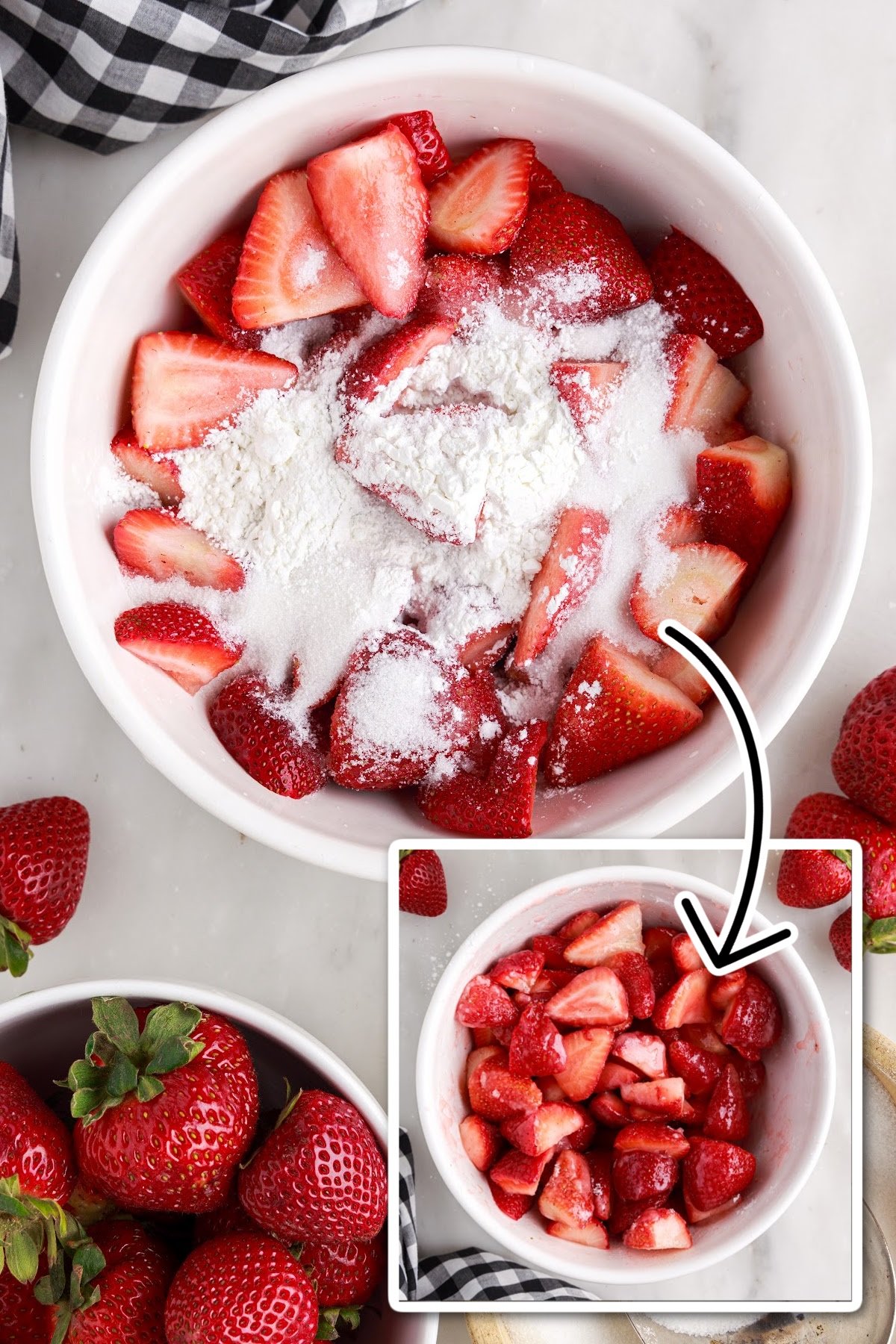 Mixing the cornstarch and sugar into the cut up strawberries in a bowl, with other ingredients in the background.
