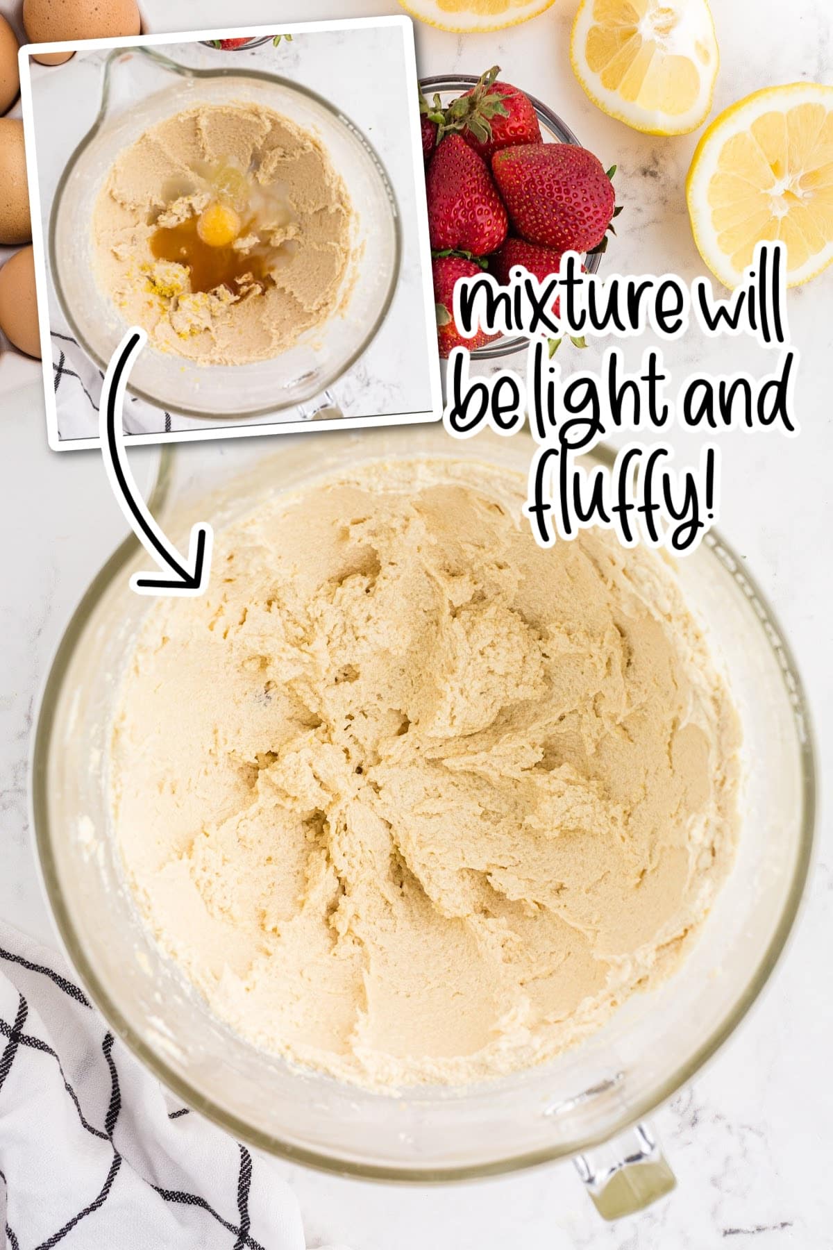 Adding in the eggs and lemon, and extracts and mixing until smooth, with lemons and strawberries in the background.