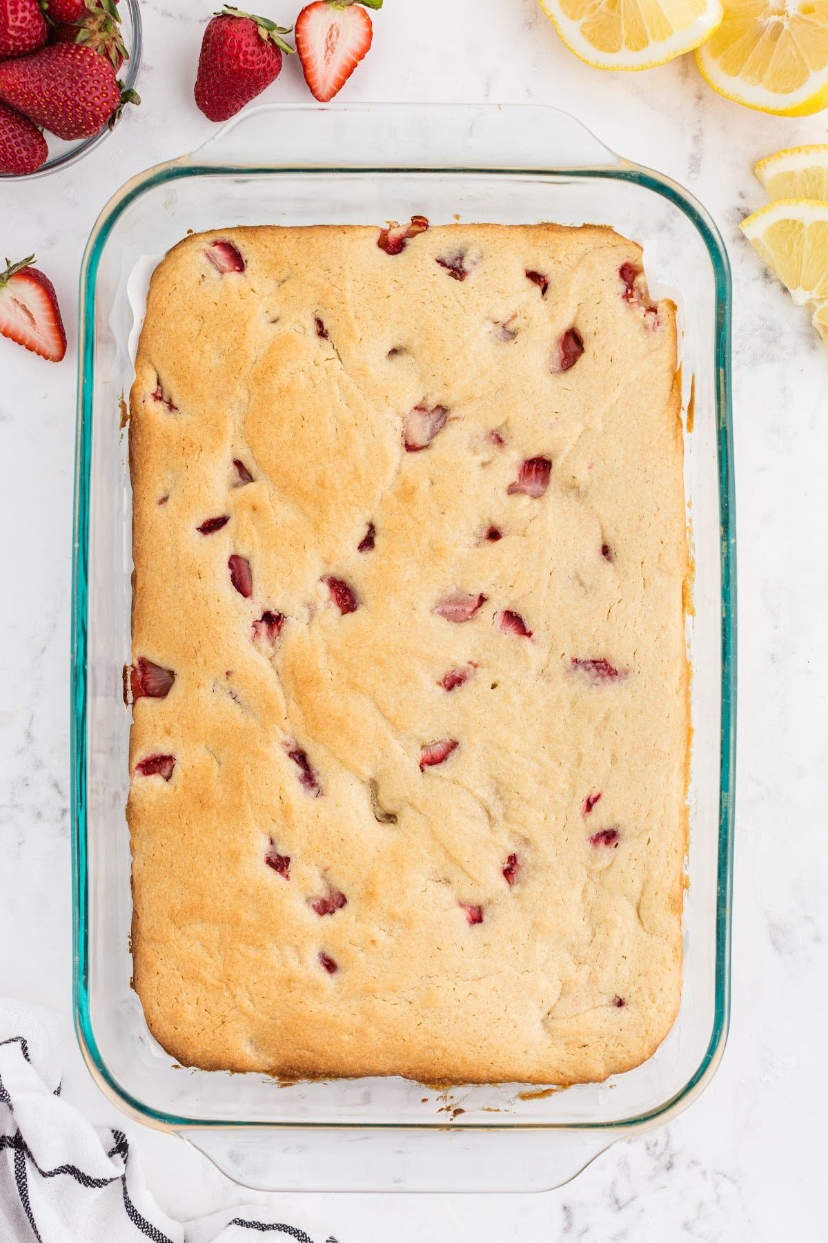 Fully baked strawberry blondies in a baking dish on the counter.