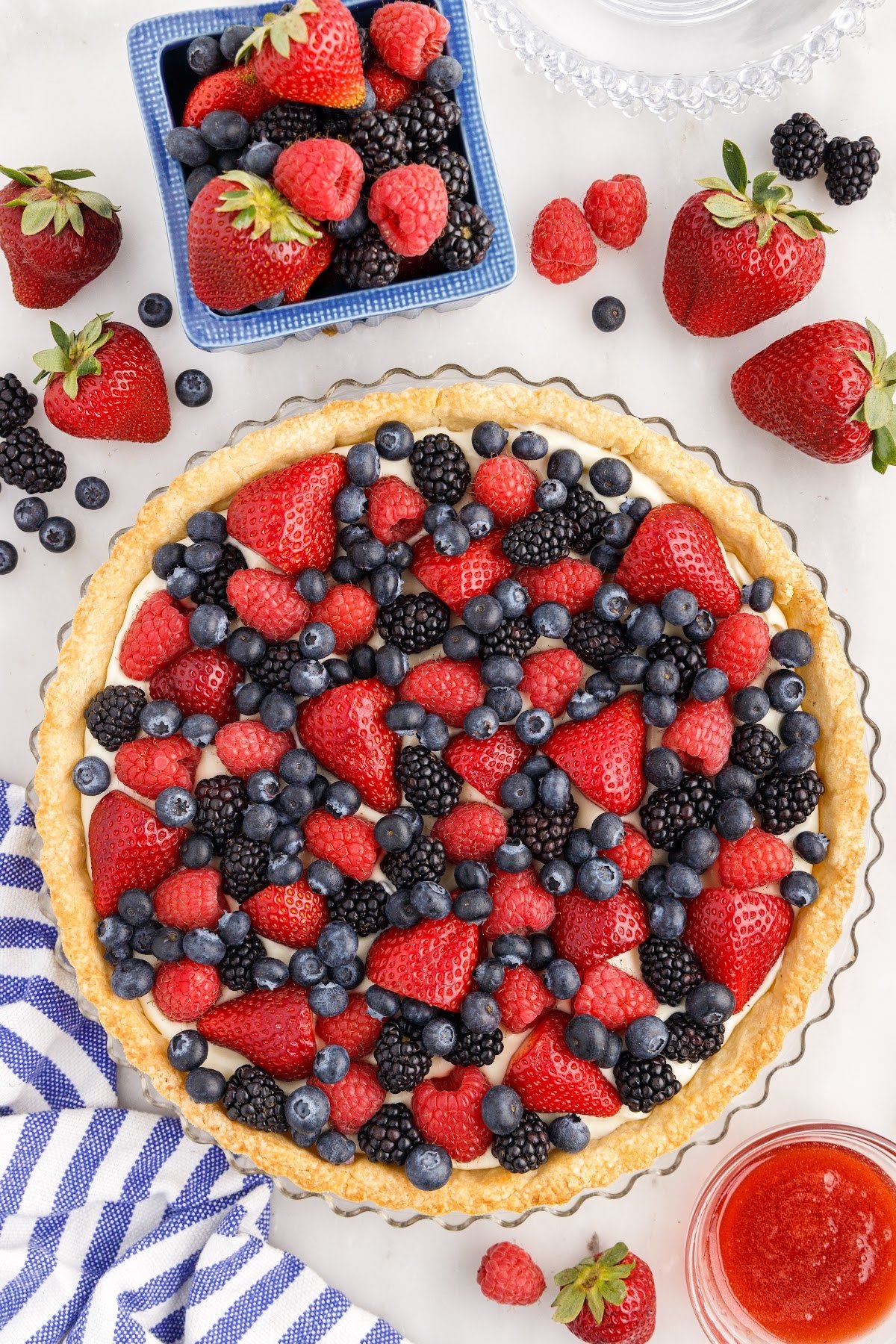 Fresh berries added to the top of the chilled pastry cream filling to assemble the Mixed Berry Tart.