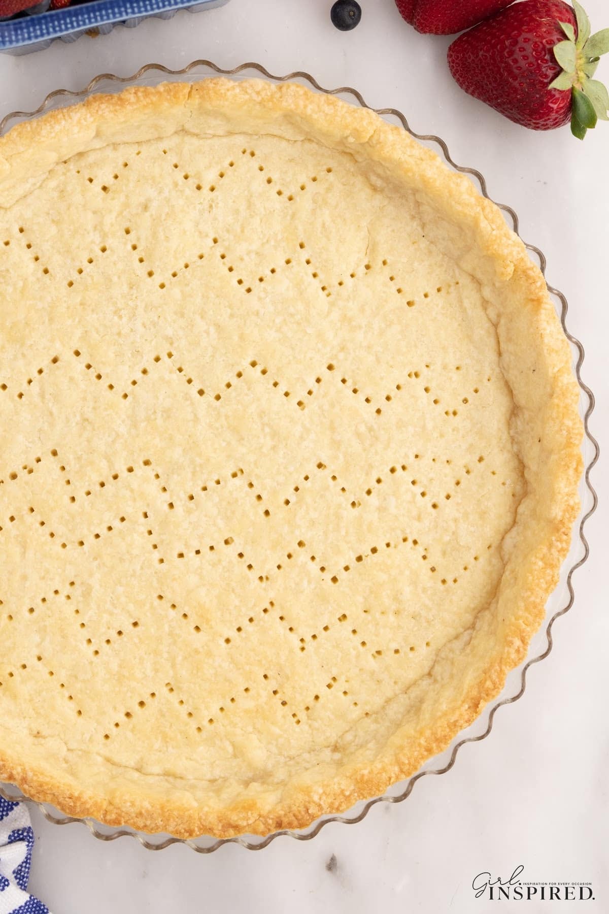 A close up of the baked pate sucree pastry shell in a tart pan