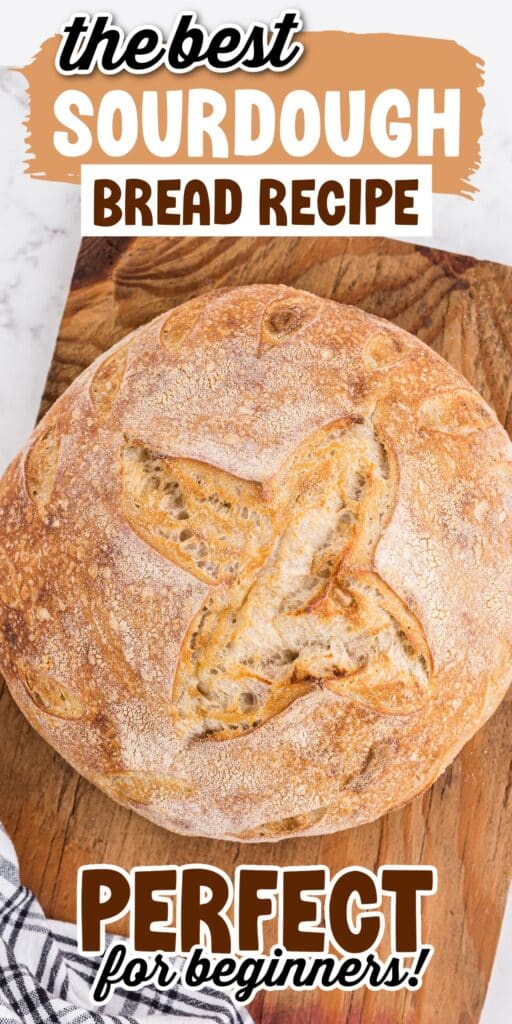 A baked loaf of sourdough bread on a cutting board.