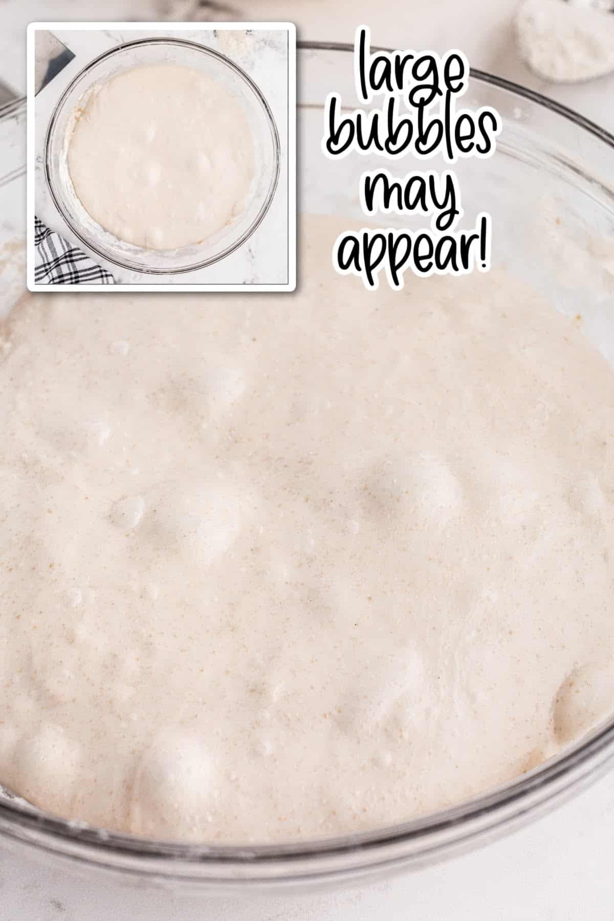 Sourdough bread dough at the end of bulk fermentation with visible bubbled on surface of puffy dough.