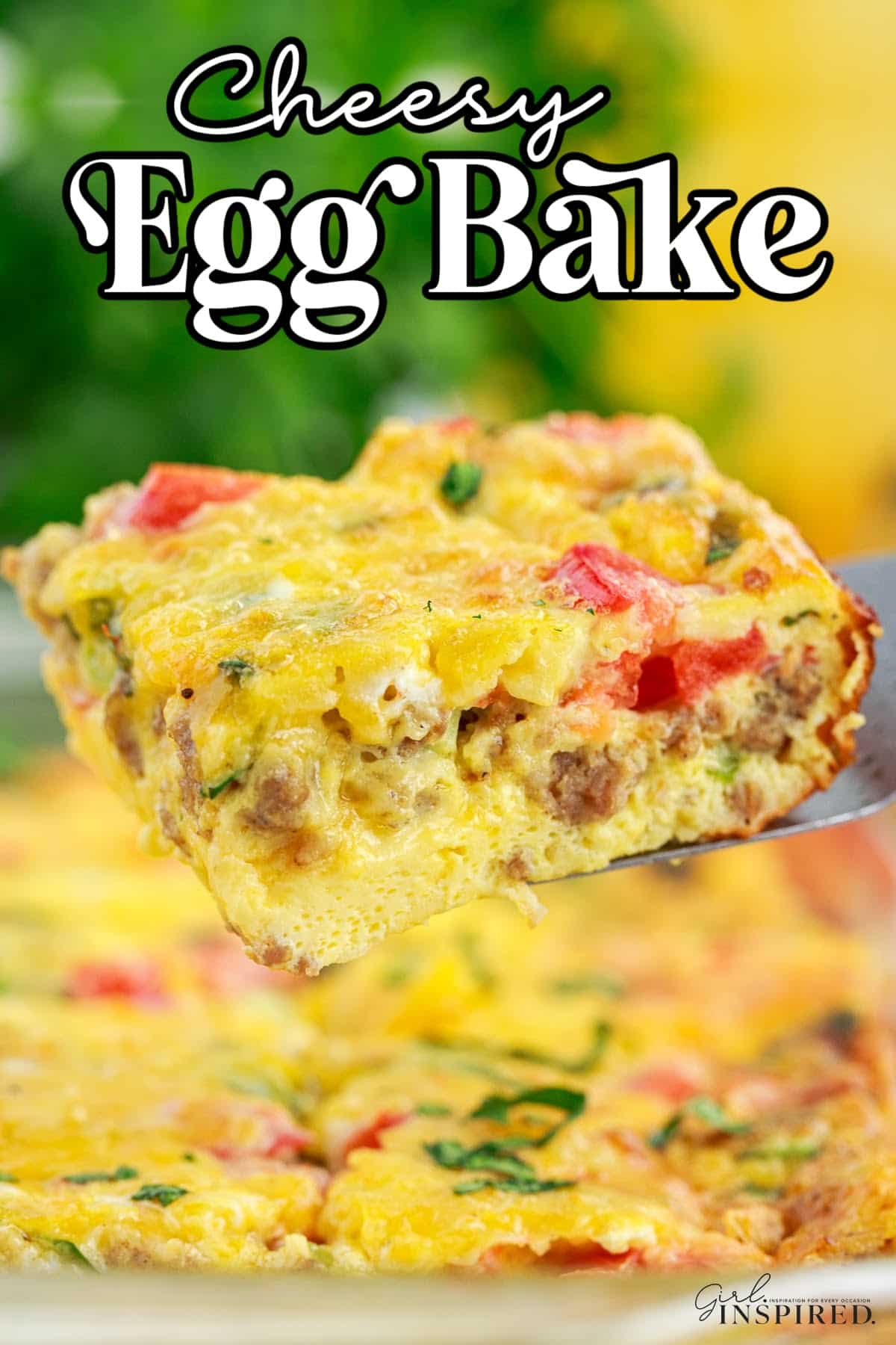 A slice of cheesy egg bake on a silver server with the rest of the cheesy egg bake in the background.