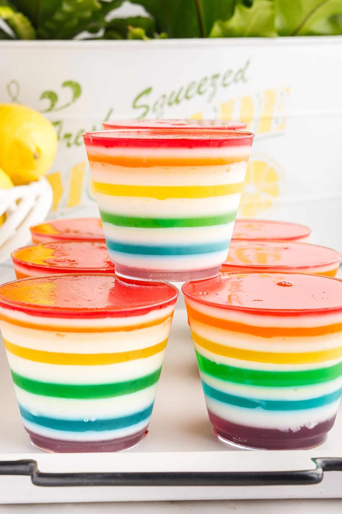 The fully assembled cups of layered jello, stacked on a serving tray.