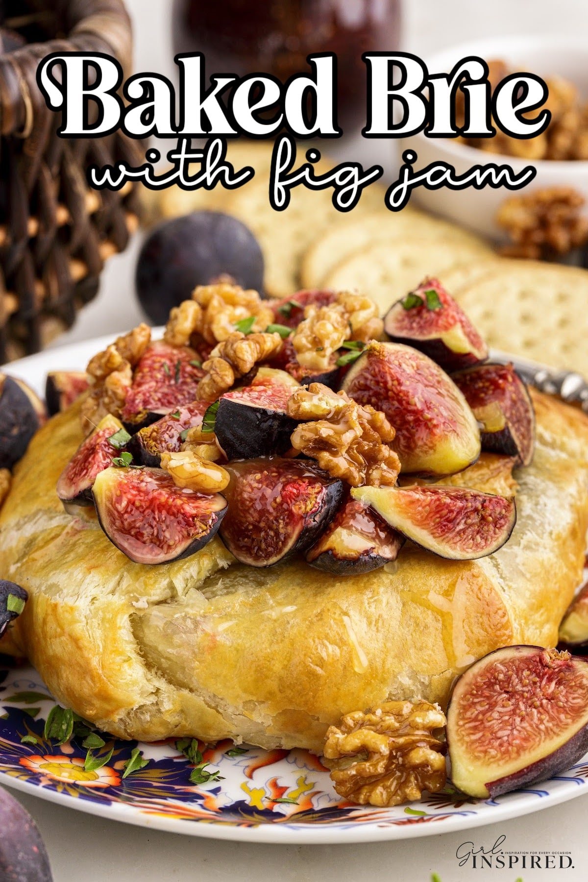 Baked brie with fig jam topped with quartered figs and chopped walnuts.