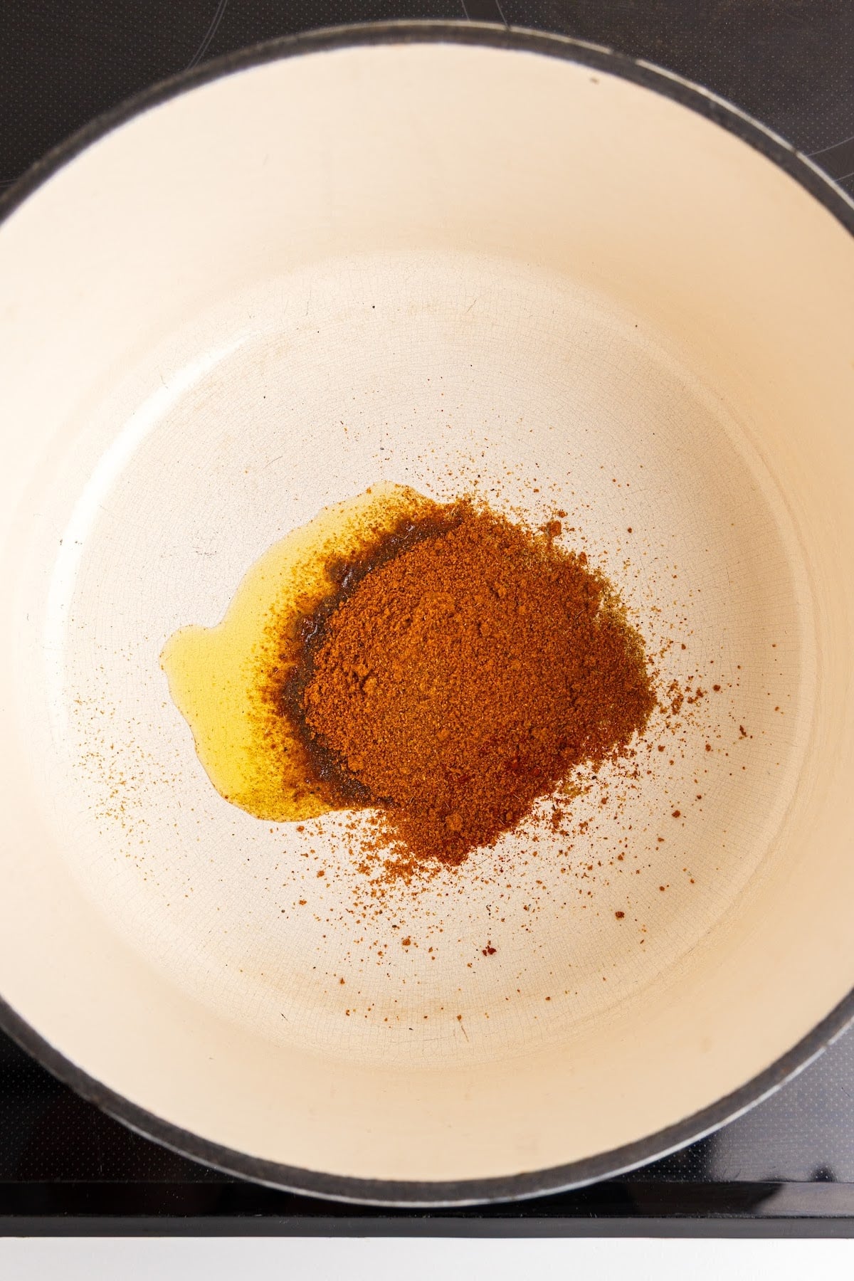 Spices for red enchilada sauce toasted in a large heavy pot over medium heat.
