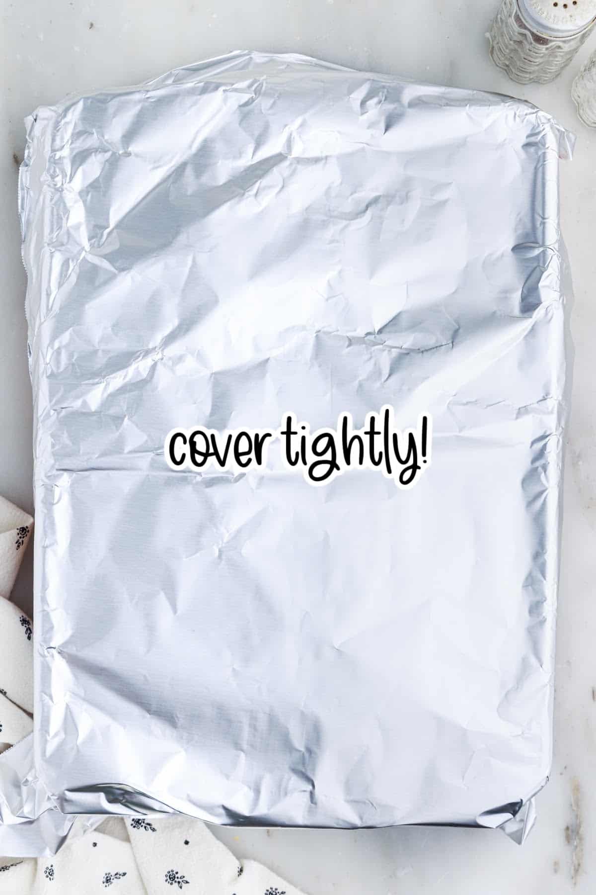 Vegetarian rice casserole dish covered tightly with foil for baking.