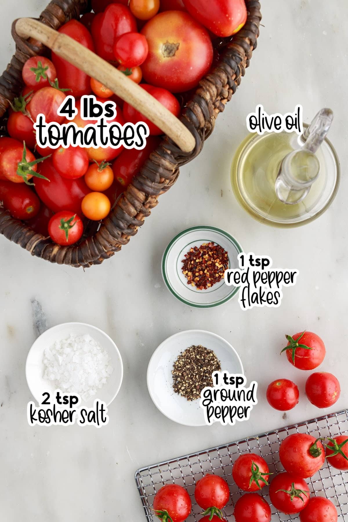 Ingredients for making sun-dried tomatoes on a marble countertop.