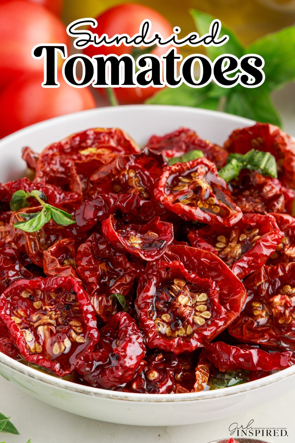 Sun-dried tomatoes in a bowl. Fresh tomatoes in the background.